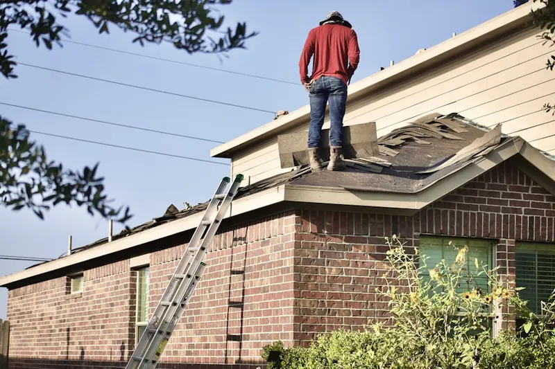Professional roofer working on a residential roof in Dolores
